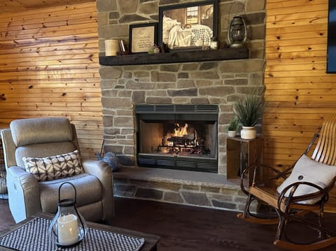 family room with a fire in the fireplace