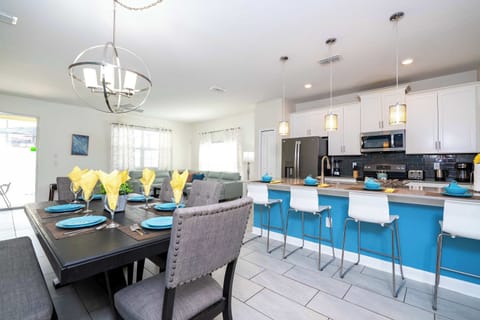 Gather and dine in style! This open-concept kitchen and dining area features modern decor, a huge island, and ample seating for memorable group meals.