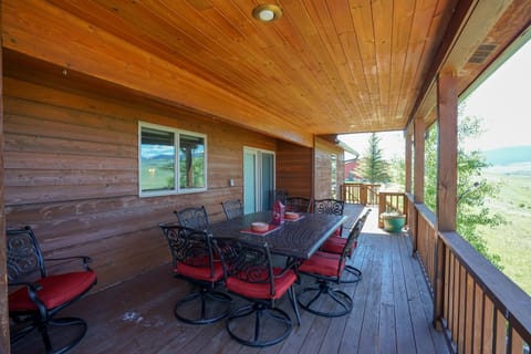 Main floor deck with outdoor seating, looking over the Madison River