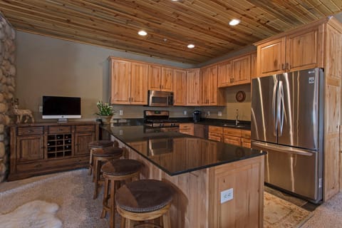 Bar seating connects the kitchen to the living area