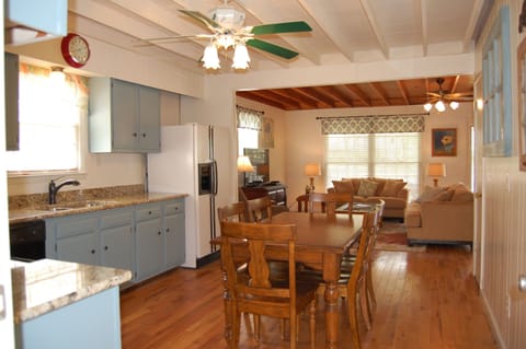 Hardwood floors and exposed cedar ceilings throughout with open floor plan.