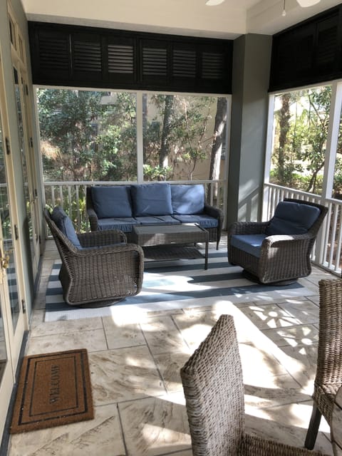 Screen porch overlooks lovely lagoon where an alligator may be catching some sun