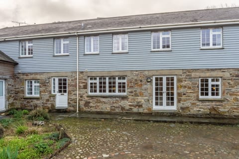 No. 2 The Fish Cellars, Port Isaac. The property is approached through a pretty courtyard with cobbled stones and has allocated parking for two cars