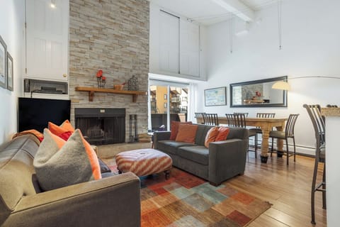 Living/dining room - open loft floor plan with fireplace & hardwood floors.