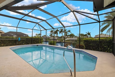 The saltwater pool is both solar and electric heated, with a peaceful canal view right through the screen.