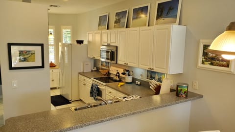 View of the fully equipped kitchen from the dining area.