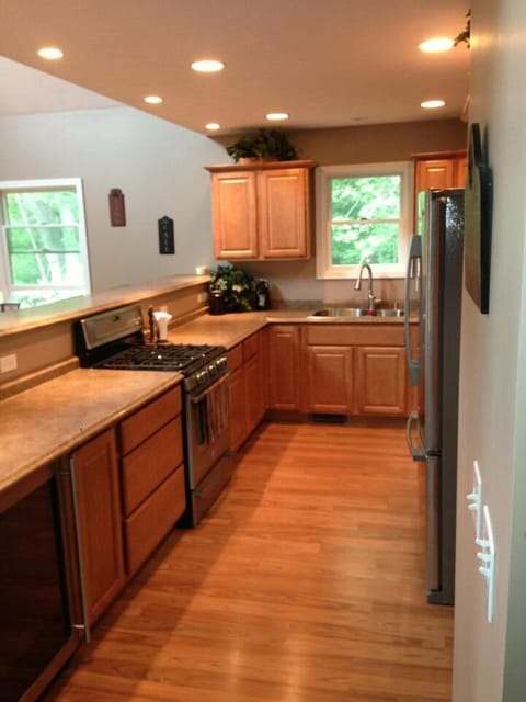 Full kitchen with gas range, stainless appliances and beverage cooler