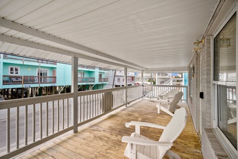 Unwind on your private deck with comfortable seating and charming views of colorful beach houses.