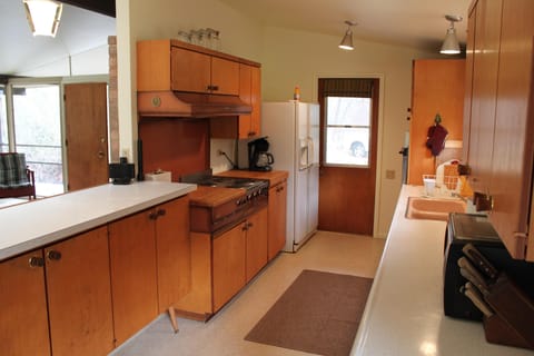 Kitchen with two (2) ovens, stovetop, new refrigerator, and microwave