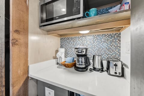 Closet and kitchenette with microwave, coffee maker and mini fridge