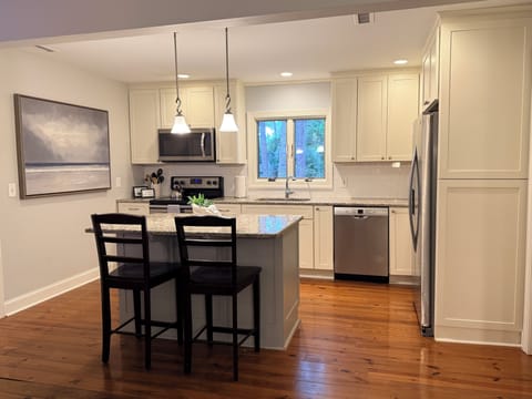 Beautiful and bright renovated kitchen with granite countertops and an island