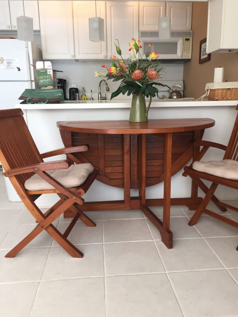 The Teak Dining Room table unfolds to seat 4 guests.