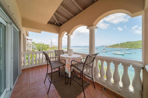 Outside front balcony over looking Cruz Bay with seating for four