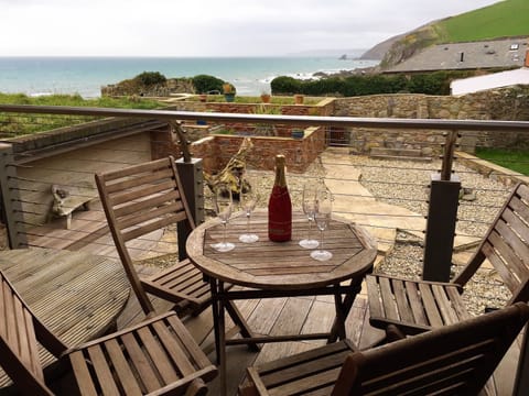 Sit, relax and hear the waves crashing on the beach below