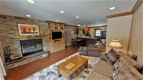 Unwind in your spacious living room, warmed by the stone fireplace and filled with natural light. Relax on plush sofas after a day of adventure, enjoying mountain charm and modern comfort.