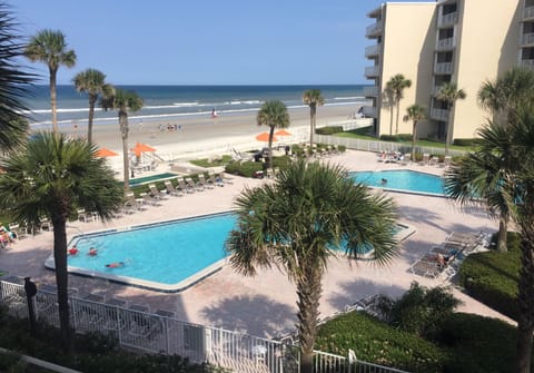 Steps to the sand — pool, beach, and ocean just outside your door