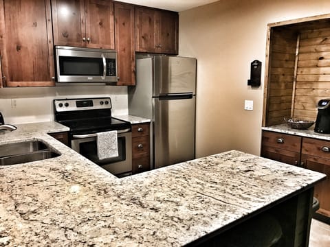 1 of 2 kitchens, all new cabinets, stainless appliances, granite & coffee bar