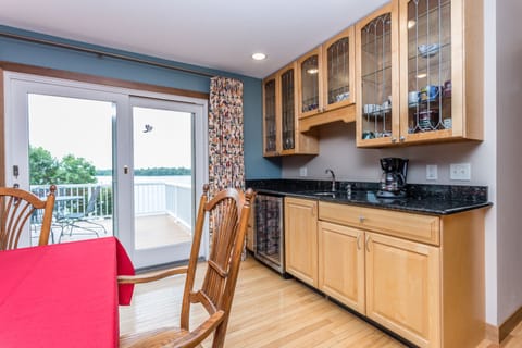 Coffee bar with sink, drink fridge, Keurig and drip coffee pots.