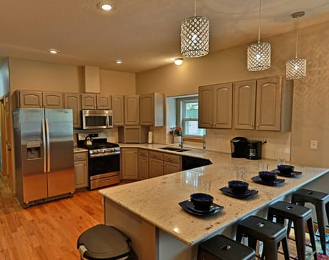 Stainless steel appliances and seating for 4 at the bar. 