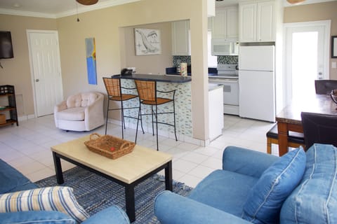 View from gathering room corner to kitchen | backdoor to parking spot on right