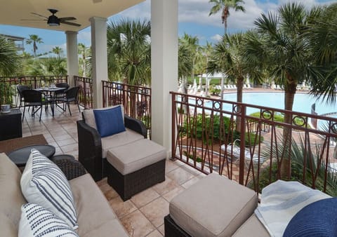 Spacious balcony overlooking 12,000 ft² lagoon pool — lounge, dine, and soak up the view!
