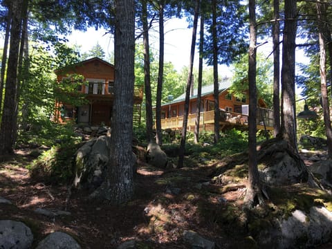 Cabin and garage room view from lake.  dock.  It is a WOW