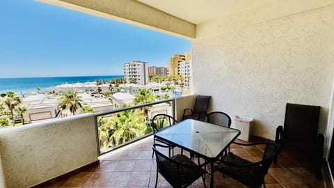 View of the Sea of Cortez from the balcony.  Two lounge chairs for tanning from the
patio .Table and Four chairs for dining.