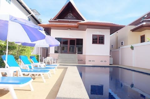 Majestic Villas 1, 2 bedroom. Rear view of villa and pool area with loungers.