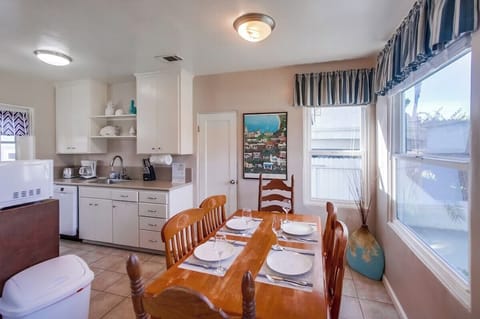 Dining table for 6 with view into the kitchen and pantry closet