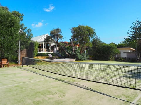 View from tennis court to deck and back of house.