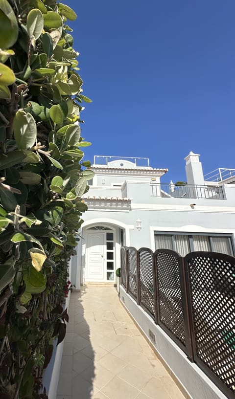 Villa Flores entrance & front door, approached via a few steps.