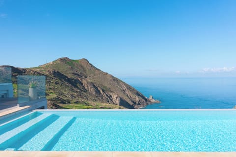 Outdoor area with : 35 sq. m infinity swimming pool, sun beds , umbrellas, etc.