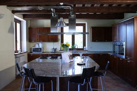 Large kitchen with granite island as focal point