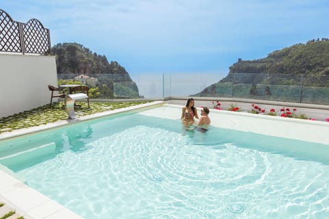Seasonal outdoor pool, open 10:00 AM to 9:00 PM, pool umbrellas