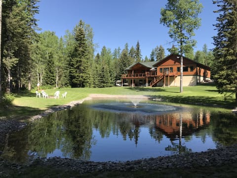 Vrbo 647022 back side of home, backyard with spring fed pond for swimming.