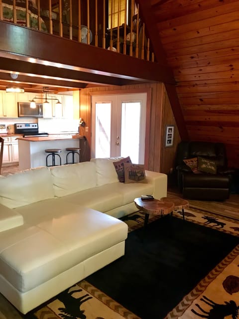 Newly furnished great room with open floor plan connecting to kitchen. 