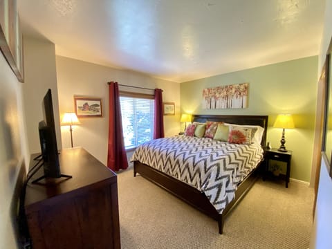 Sunny Master Bedroom with a King Bed, Large Closet, Smart Roku TV & DVD Player.