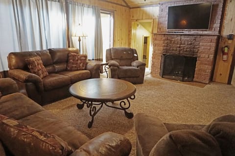 Sink into plush leather seating in your spacious living room, complete with a cozy fireplace and large flat-screen TV for your perfect mountain retreat evenings.