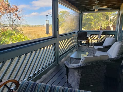 Comfortable screened seating to watch the wildlife on the marsh and the sunset. 