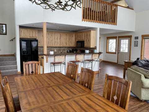 Kitchen with bar and three stools.