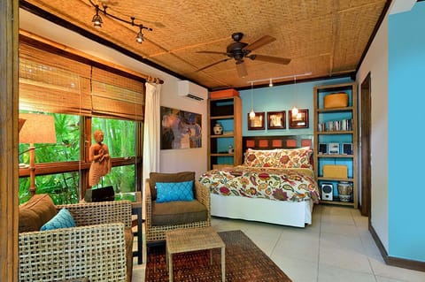 The combination sitting and sleeping area with a queen size bed.