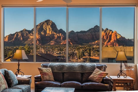 Living room showing view of Sedona red rock formatio through huge front windows.