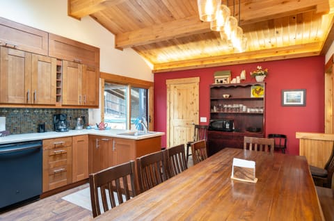 A dining table in the kitchen seats 10 and offers an open, inviting view to the living room, making it ideal for both everyday meals and entertaining