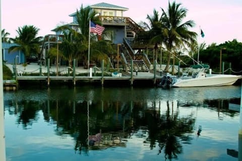 View of the house & its 100 ft dock while approaching by boat from the canal.