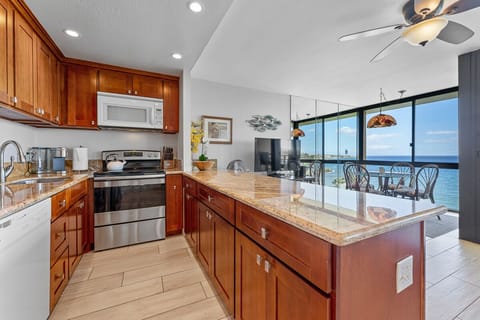 Peninsula style kitchen with cherry cabinetry.