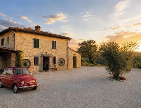 Belvedere’s main courtyard, with farmhouse views and Tuscan hills beyond.