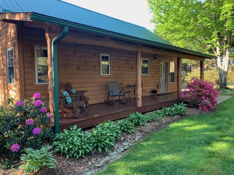 Sheltered front porch featuring comfortable seating for a inviting ambiance.