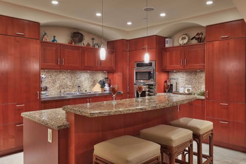 Spacious kitchen with granite counters and travertine floors