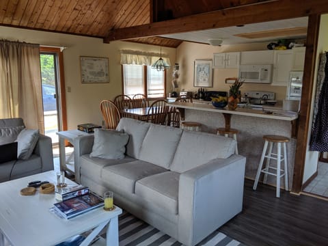 Open-concept living room / dining room/ kitchen.  Very high ceiling.  Timbers.