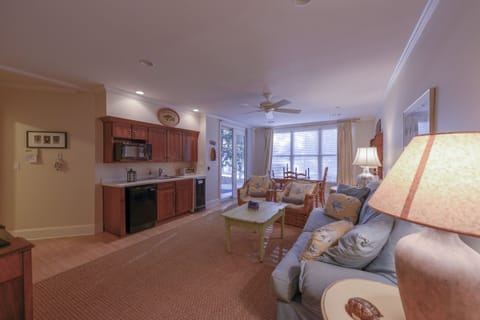 Another view of lower level den w mini kitchen  w dining table overlooks lake